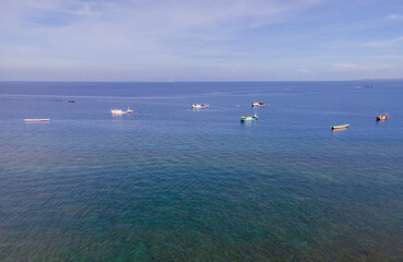 Beautiful aerial view of Kelapa Lima Beach with many traditional boats, a tropical beach and coastline located in Kupang, East Nusa Tenggara, Indonesia.  