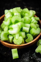 Pieces of fresh celery in a wooden plate. 