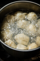 Dumplings are boiled in a saucepan in boiling water. 