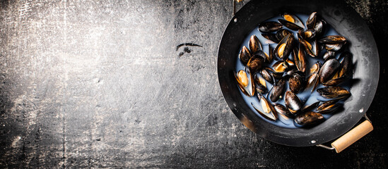 Pot of mussels on the table. 