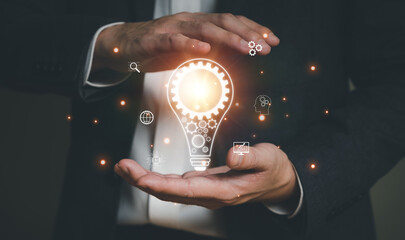 Business person dress in formal suit holding an icon that show the component of Business that do digital transformation and AI technology for industrial or marketing business.