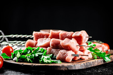 Fresh raw pork kebab on a cutting board. 
