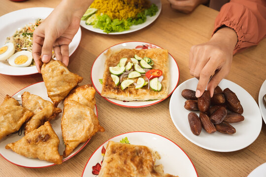 Top view People and family eating after fasting in Ramadan mubarak iftar. Meal with various menu Date palm mataba.