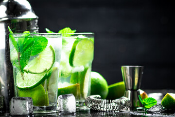 Traditional mojito with pieces of lime and mint. 
