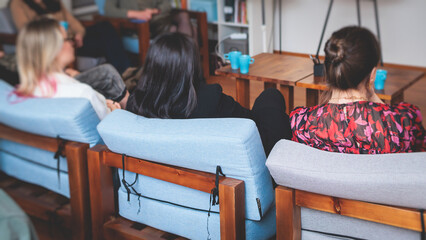 Female participants audience at the symposyum meeting,  attendees in conference room hall listens...