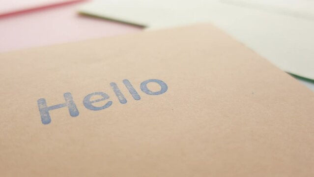 close up of hello text in blue color on a envelope 