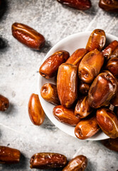 Full bowl with dates on the table. 