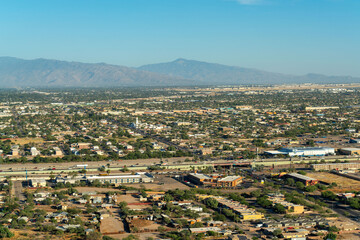 Suburban or uban area of the city in Tuscon Arizona in the Sonora desert in the harsh sunlight and with moutains