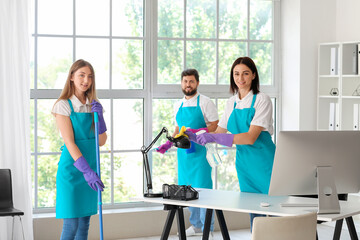 Young janitors cleaning in modern office