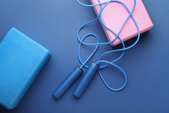 Skipping rope with blocks on blue background