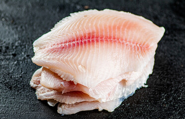 Uncooked fish fillet on the table. 