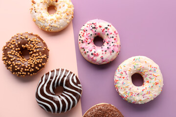 Delicious glazed donuts on color background