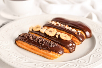 Plate of delicious chocolate eclairs, closeup