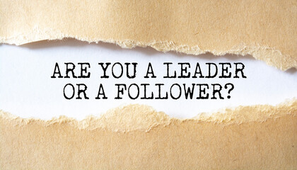 Are You a Leader or a Follower? word written under torn paper.
