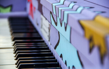 Purple piano with colourful shapes