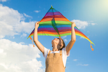 Beautiful teenage girl holding a kite a dream travel to distant countries.