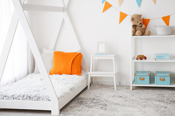 Stylish interior of children's room with baby bed