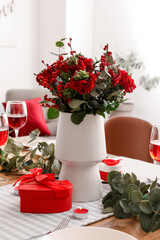 Table setting for Valentine's Day with beautiful flowers in dining room, closeup