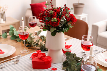 Table setting for Valentine's Day with beautiful flowers in dining room, closeup