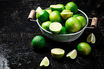 Fragrant lime with leaves in a colander. 