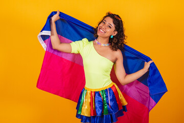 beautiful afro american brazilian woman in carnival clothes holding bisexual lgbt flag. Bisexual pride. - obrazy, fototapety, plakaty