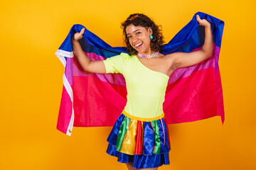 beautiful afro american brazilian woman in carnival clothes holding bisexual lgbt flag. Bisexual pride.