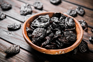 Prunes wooden plate on the table. 
