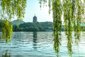 Leifeng Pagoda with its reflection in West Lake and willows around West Lake in summer © Gavin