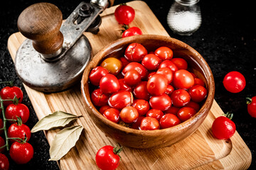 Pickling ripe tomatoes on a cutting board. 