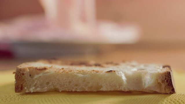 Putting mortadella on rustic bread