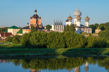 Fototapeta premium Domes of the ancient Tikhvin Assumption Monastery in the summer landscape on a sunny August morning. Leningrad region, Russia