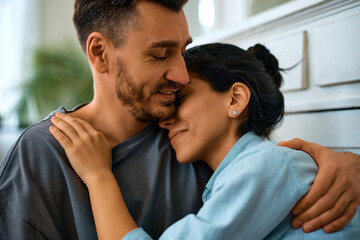 Fototapeta premium Affectionate couple in love embracing at home.