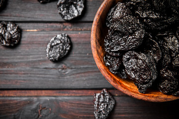 Prunes wooden plate on the table. 