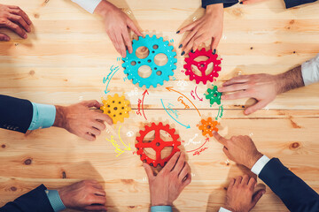 Business team connect pieces of gears like a teamwork and partners