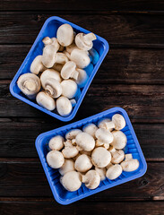 Mushrooms in a plastic box on the table. 