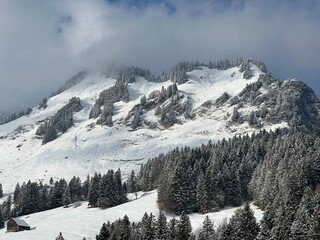 Snow-capped alpine peak Raaberg (1723 m), easternmost summit of the Mattstock massiv and above the Lake Walen or Lake Walenstadt (Walensee), Amden - Canton of St. Gallen, Switzerland / Schweiz