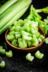 Pieces of fresh celery in a wooden plate. 