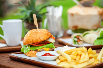 Juicy cheeseburger with melted cheddar, served with crispy french fries