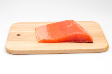 Fresh salmon fish fille on wooden cutting board