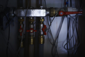 White modern aluminum radiator battery for hot water heating, on the background of a wall in the interior of an apartment or office space.