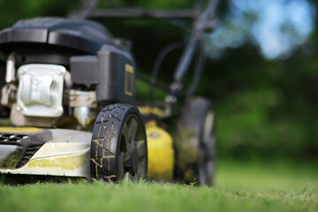 Lawn mover on green grass in modern garden. Machine for cutting lawns.
