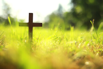 Concept conceptual black cross religion symbol silhouette in grass