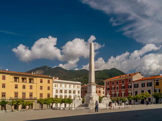 The obelisk in Piazza Aranci square, Massa, Italy, on a sunny day 