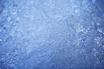 Blue water texture. Bubbles and bubbling water.