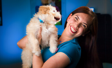 beautiful model with her maltipoo dog playing bites