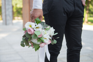 delicate wedding bouquet in the hands of the groom. idea for event agencies