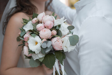 wedding flowers in the hands of the bride and groom. concept for event agencies
