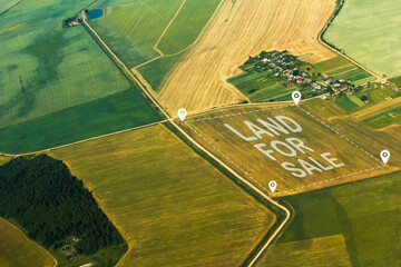 The concept of selling land and residential real estate on the land market is an aerial shot with...