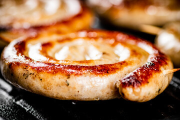 Grilled sausages in a frying pan. 