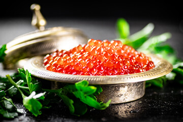 Full bowl of red caviar on the table. 